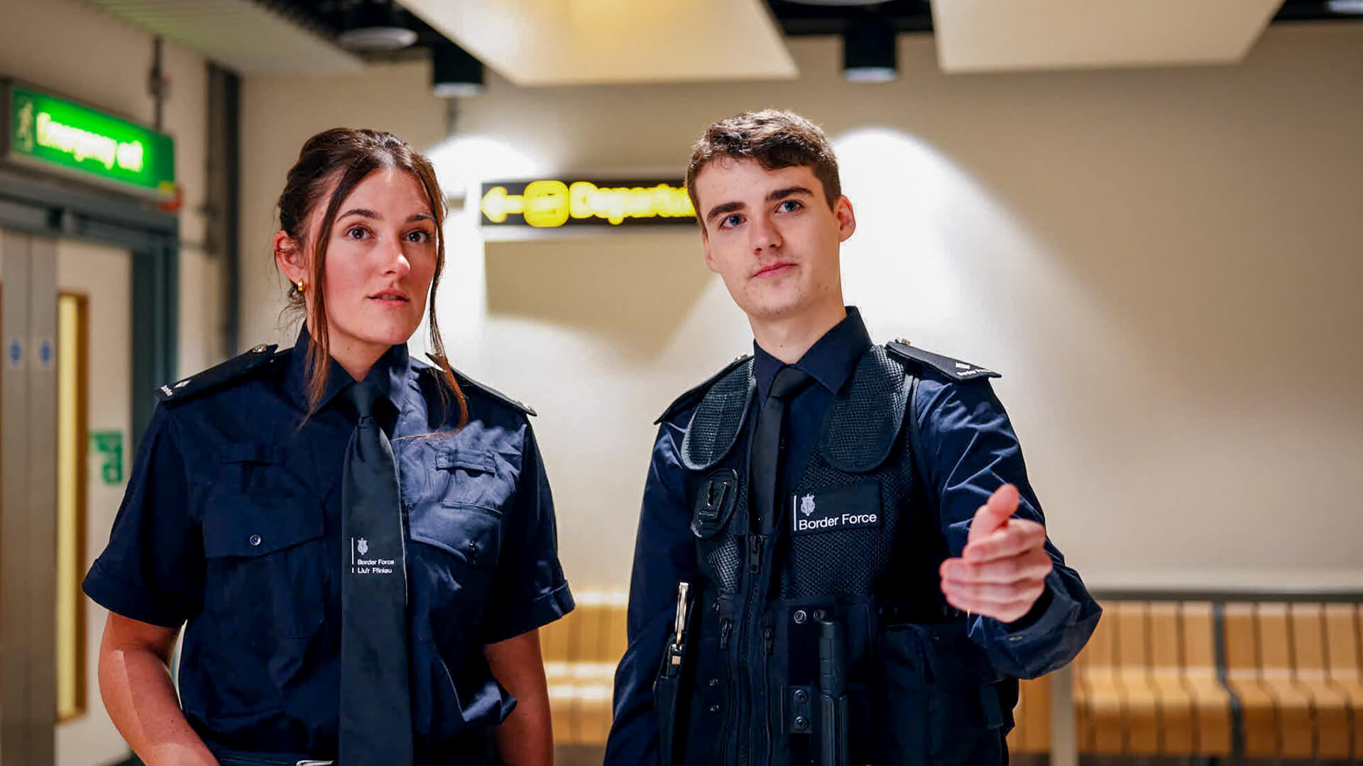 Two people standing in a corridor