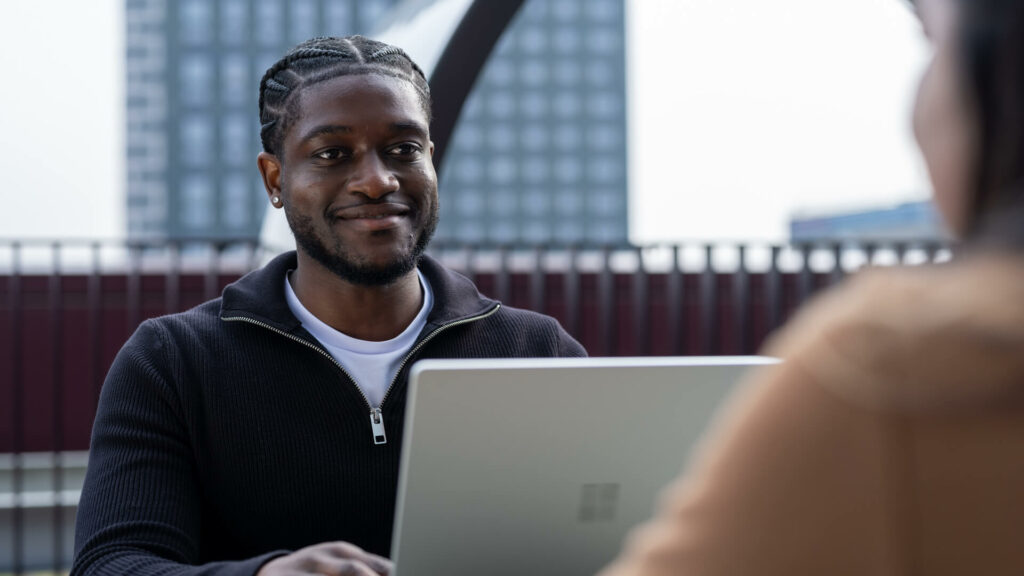 Man sitting at desk with laptop