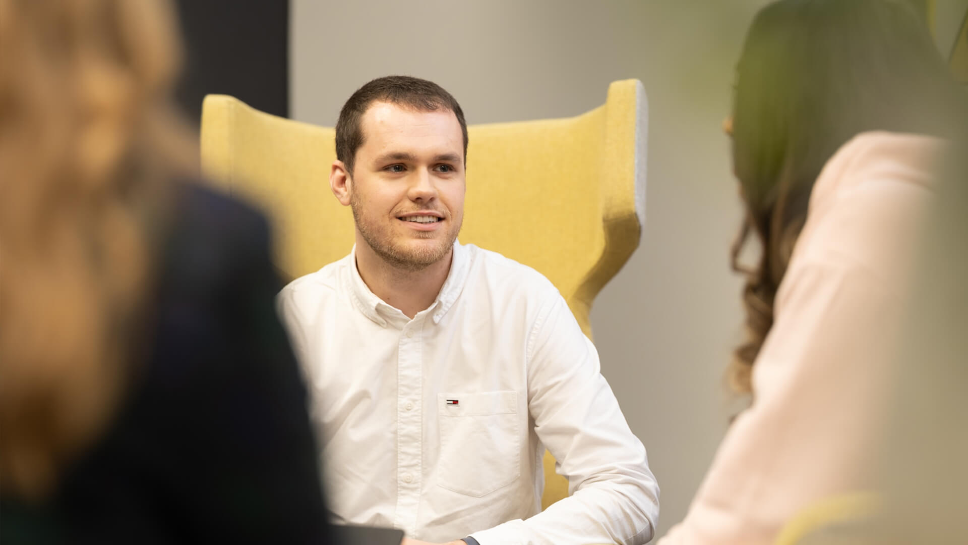 Interview-style discussion taking place in a modern office environment.