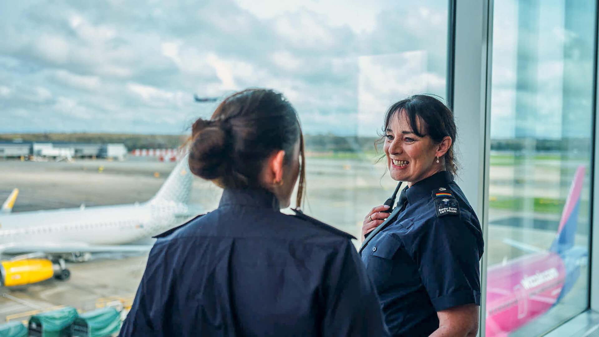2 staff at an airport having a discussion