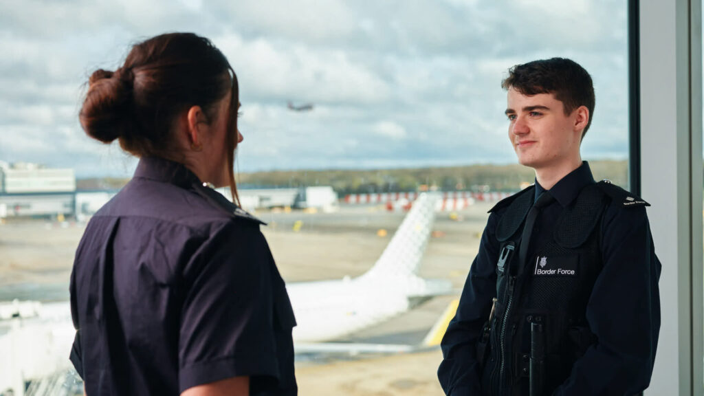 2 staff talking in an airport terminal